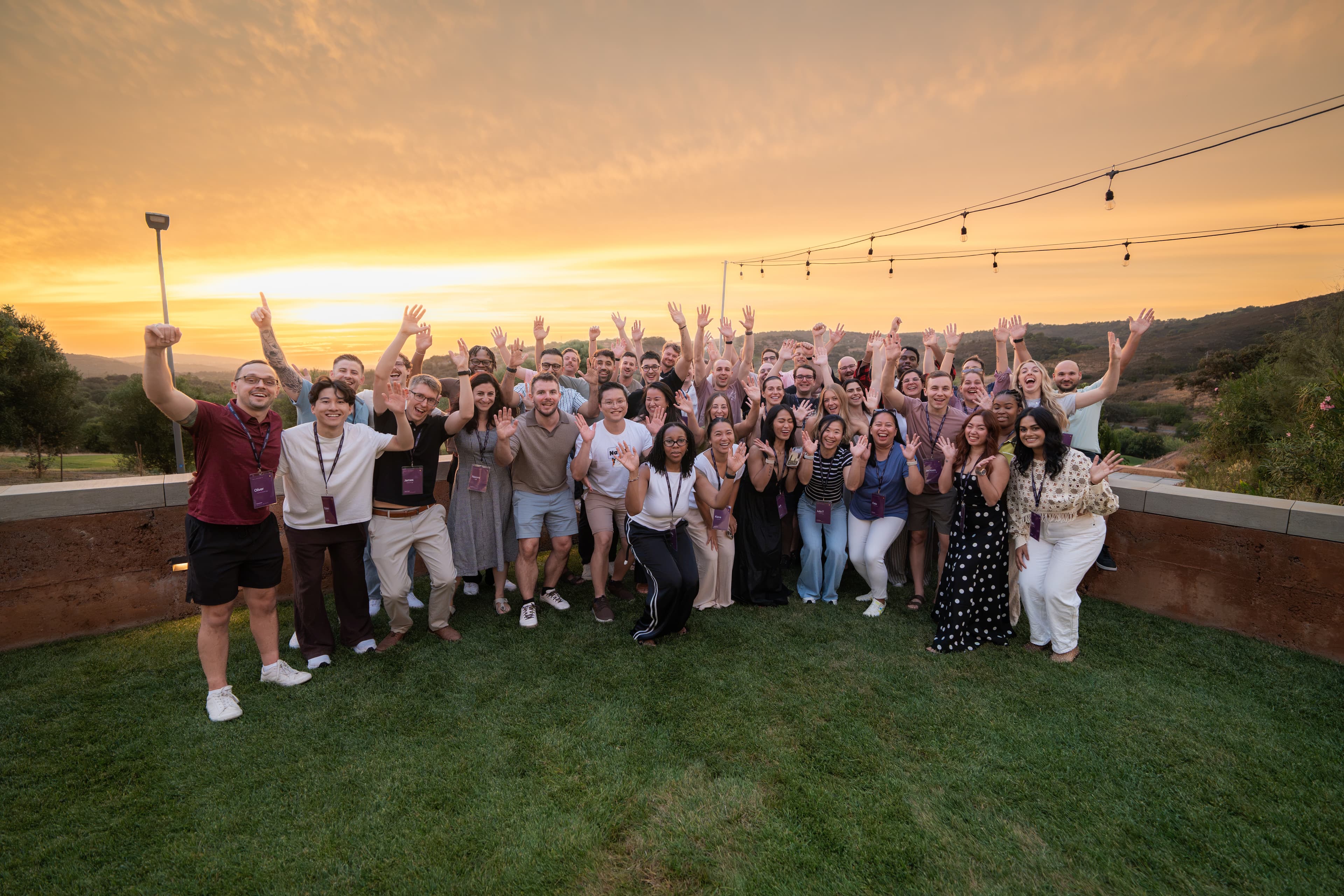 Junction team waving at sunset during the company offsite